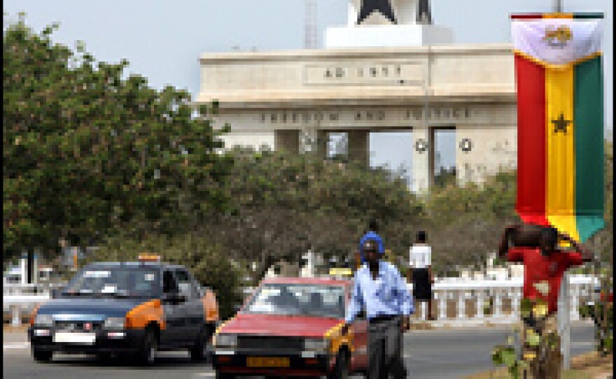 Motorists pass a monument dedicated to Ghana's independence in the capital of Accra.