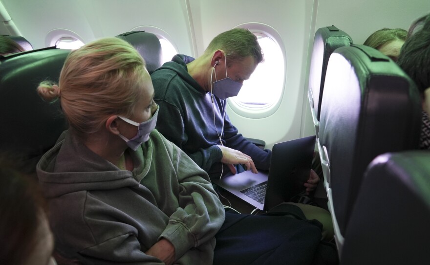 Navalny and his wife Yulia sit in the plane and watch <em>Rick and Morty</em> together on Jan. 17, 2021.