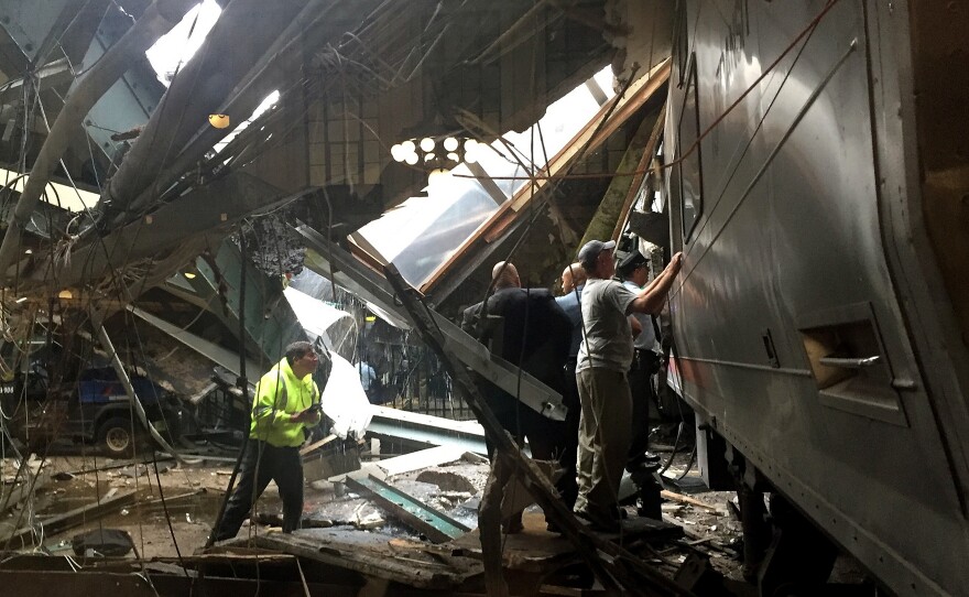 Passengers walk to safety after a NJ Transit train crashed in to the platform in Hoboken, N.J., on Thursday morning.