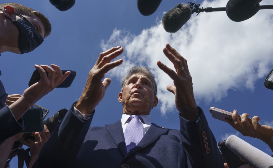 Sen. Joe Manchin, D-W.Va., speaks with reporters on Capitol Hill on Sept. 30, 2021.