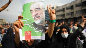 Iranian supporters of defeated reformist presidential candidate Mir Hossein Mousavi carry his image as they demonstrate in the streets on June 15, 2009 in Tehran, Iran. Crowds of people gathered to protest the re-election of Iran's President Mahmoud Ahmadinejad, who won a second four-year term in a landslide election victory on June 12. 