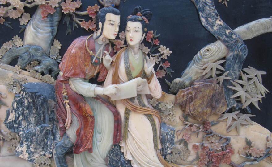 The romance between star-crossed lovers Jia Baoyu (left) and Lin Daiyu, depicted here in a relief panel, meets a tragic end in the classic Chinese novel <em>Dream of the Red Chamber</em>.