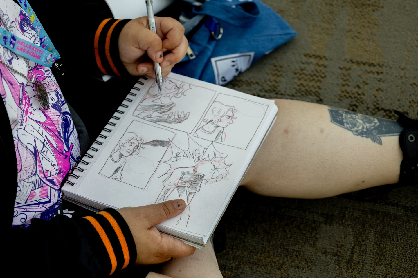 An attendee sketches while taking a break during Comic-Con, July 24, 2026.