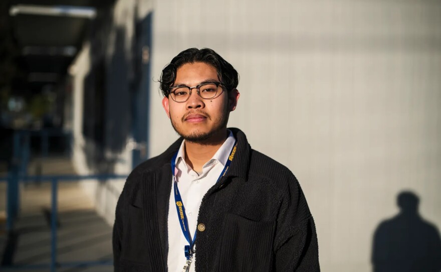 Karl Molina, 25, who teaches sociology with an emphasis on ethnic studies, stands near the classroom where he teaches at Romona High School in Riverside on March 28, 2023.