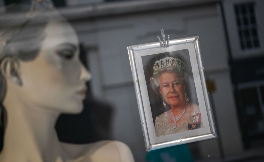 A portrait of Queen Elizabeth II hangs in a shop window in Colchester, England.