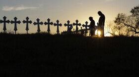 Kenneth and Irene Hernandez pay their respects as they visit a makeshift memorial with crosses placed near the scene of a shooting at the First Baptist Church of Sutherland Springs, Monday, Nov. 6, 2017. 