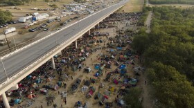Migrants, many from Haiti, are seen at an encampment along the Del Rio International Bridge near the Rio Grande, Tuesday, Sept. 21, 2021, in Del Rio, Texas.