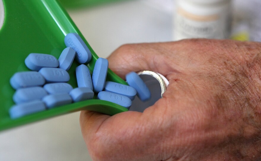 A pharmacist pours Truvada pills, an HIV treatment, back into the bottle at Jack's Pharmacy in San Anselmo, Calif.