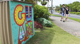 Tourists walk through a shopping district in Tamuning, Guam, May 15, 2017.