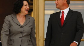 Supreme Court Justice Sonia Sotomayor and Chief Justice John Roberts step outside the Supreme Court in Washington on Tuesday for photos after an investiture ceremony with their colleagues.