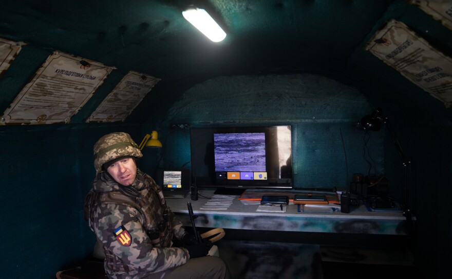 A soldier tests out monitoring the drone.