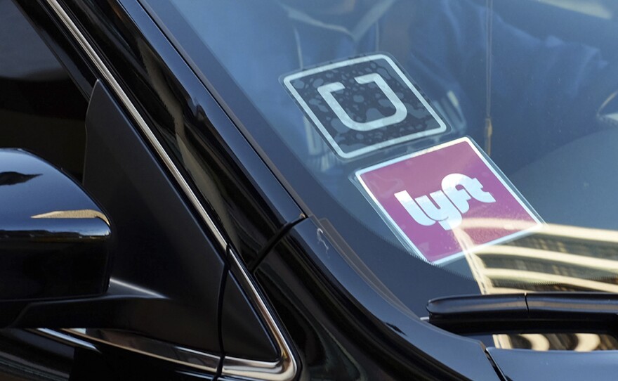 Uber and Lyft decals on a car in this undated photo