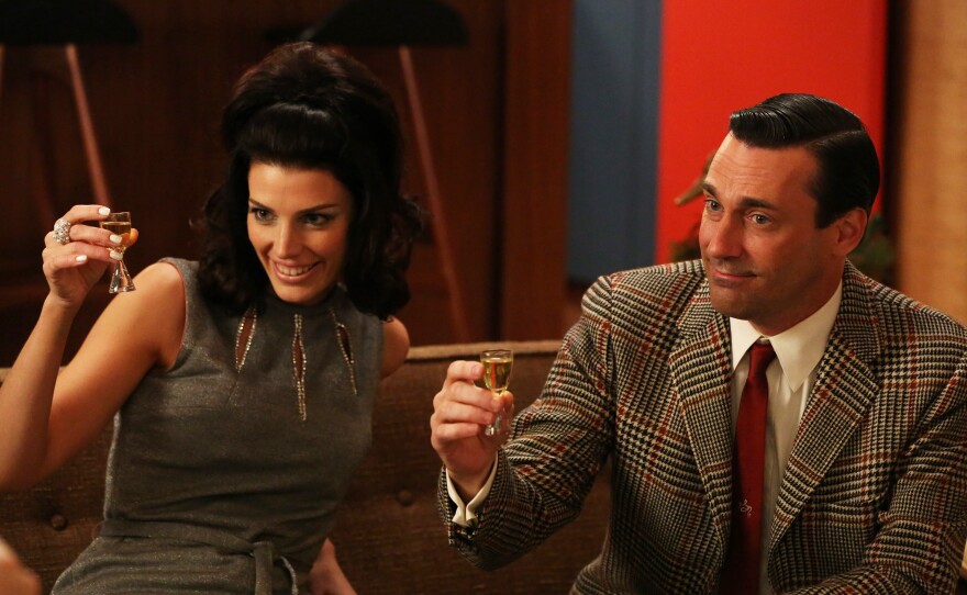 Megan Draper (Jessica Pare) and Don Draper (Jon Hamm) raise their glasses. Many fans have been inspired to do the same, but Mad Men has a complicated relationship with alcohol.