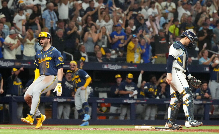 Milwaukee Brewers' Garrett Mitchell, left, celebrates past Tampa Bay Rays catcher Nick Fortes after scoring during the fifth inning of Game 3 of baseball's World Series, Monday, Oct. 26, 2026, in St. Petersburg, Fla., between the Milwaukee Brewers and the Tampa Bay Rays.
