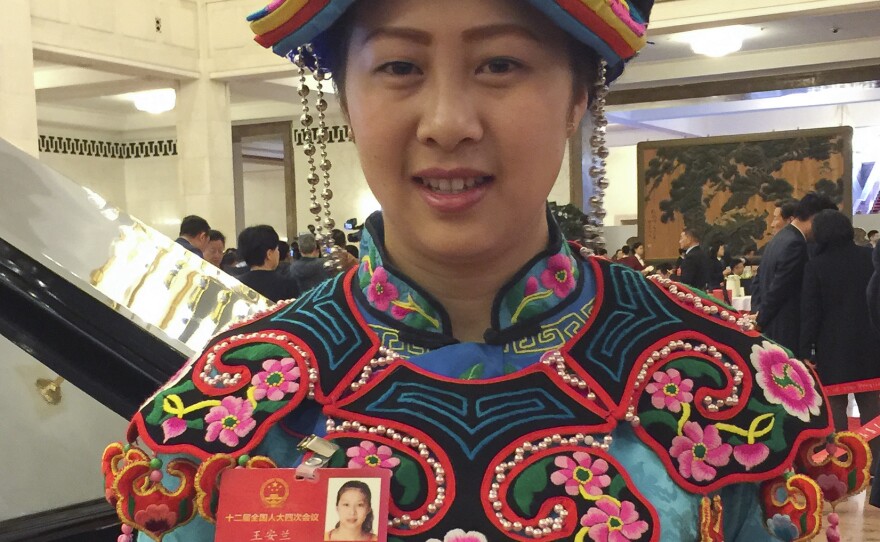 Wang Anlan, a 28-year-old National People's Congress delegate from the ethnic Qiang minority, poses for a picture in the Great Hall of the People.