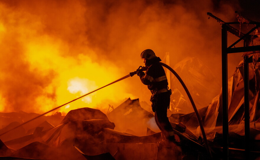 Firefighters put out a fire after Russian missiles hit a warehouse in Kyiv, Ukraine, Wednesday, Aug. 5, 2026.