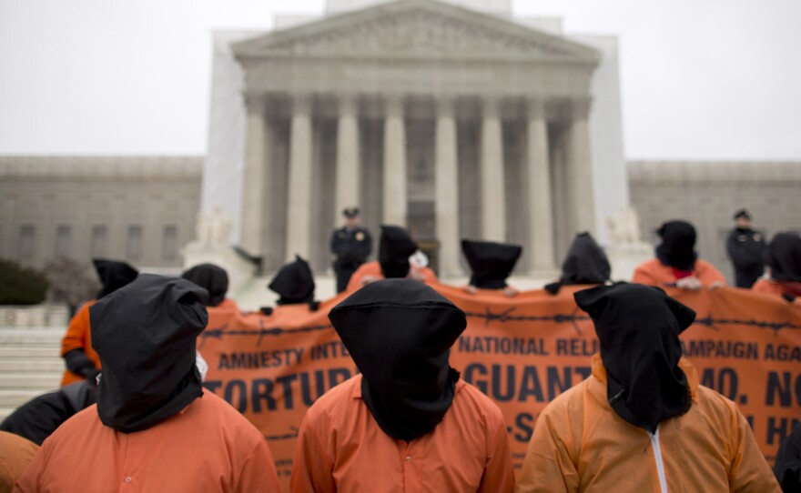 Demonstrators dressed as Guantanamo Bay detainees protest against the facility, in front of the U.S. Supreme Court in January.