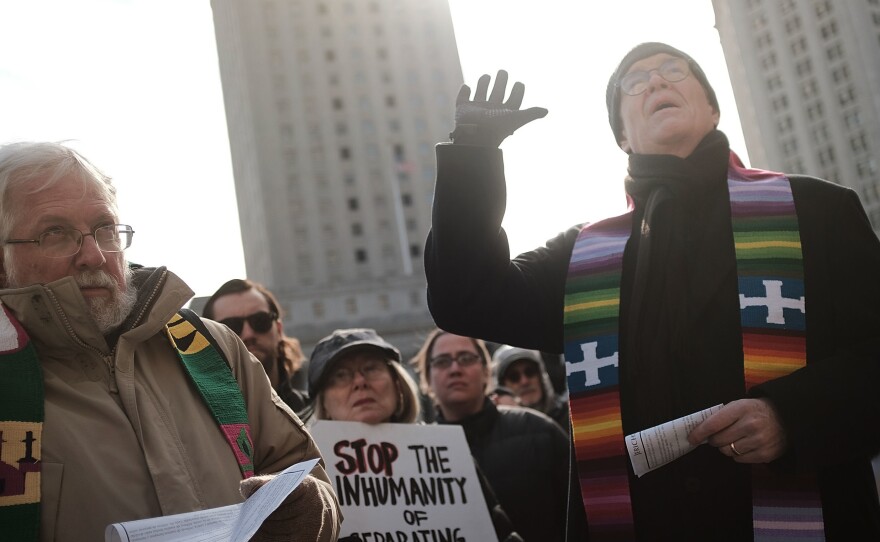 Dozens of clergy members, immigration activists and others participate in a protest against the imprisonment and potential deportation of an immigration activist. Religious liberals are becoming increasingly outspoken in their opposition to many Trump administration policies.