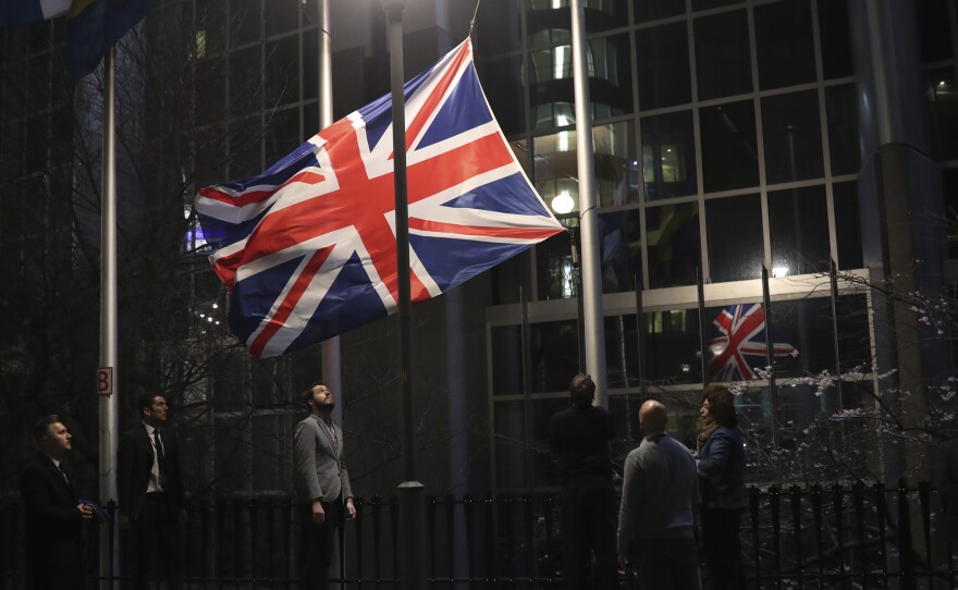 Officials lower and remove the Union Jack from the European Parliament building in Brussels on Friday. As the U.K. prepared to bring to an end its decades-long membership in the European Union, the bloc's top officials on Friday pledged to continue playing a prominent role despite the loss of a powerful affiliate.