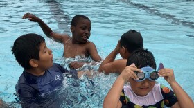 A group of boys play in the City Heights Swim Center pool, May 20, 2022.