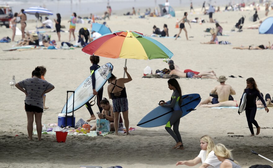 On Thursday, beachgoers flocked to Huntington Beach. Calif. Gov. Newsom announced that same day he was ordering all Orange County beaches to close, after tens of thousands gathered at the shore last weekend.