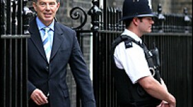 British Prime Minister Tony Blair passes a guard as he leaves 10 Downing Street Thursday.