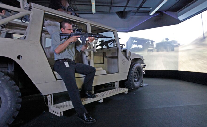 Staff members at the Army Experience Center in Philadelphia demonstrate the Humvee interactive simulator in 2009.