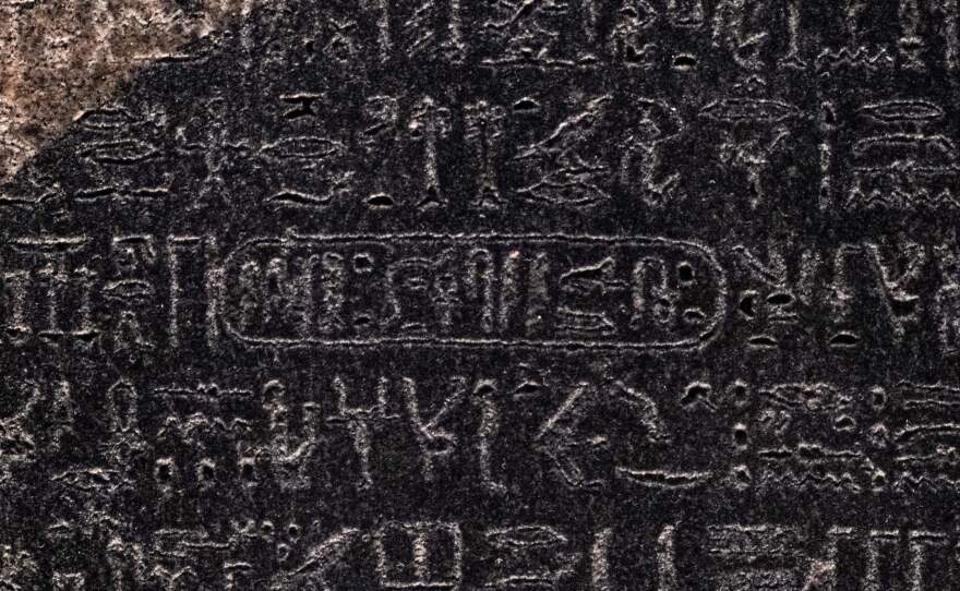 This picture taken on July 2022 shows a close-up view of the cartouche of the Ptolemaic dynasty Pharaoh Ptolemy V "Epiphanes" (210-180 BC) inscribed with the rest of the ancient Egyptian hieroglyphic text in the upper portion of the Rosetta Stone, on display at the British Museum in London.