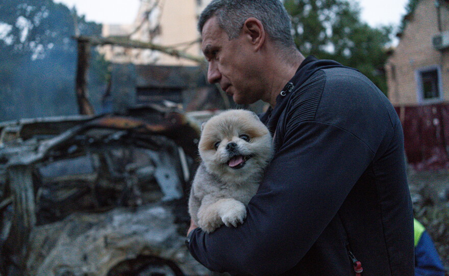 A man carries his dog after the attack on Kyiv, Ukraine on June 2.