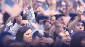 The Los Angeles Convention Center hosts a Naturalization Ceremony overflowing with proud new citizens, August 2012. Promotional image for the program "RACE 2012," a a PBS Election Special. 