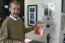 Peter Seidler holds a Wheaties box featuring Tony Gwynn.