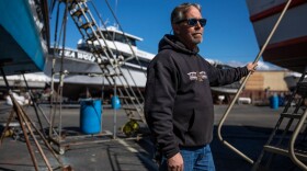 Jared Davis stands beside his charter fishing boat, Salty Lady, as it sits in dry dock in Richmond on March 8, 2023.