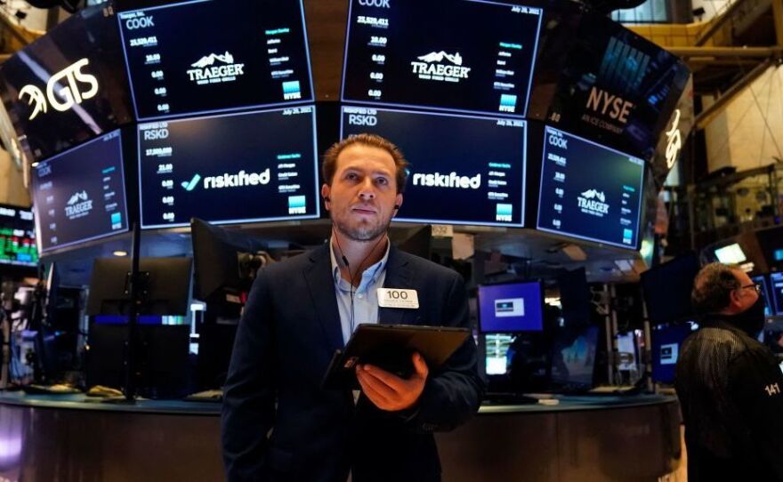 Traders work on the floor at the New York Stock Exchange this summer. Members of Congress are required to disclose their stock transactions under a law known as the STOCK Act, but an outside ethics group filed complaints noting that some lawmakers are violating the rules.