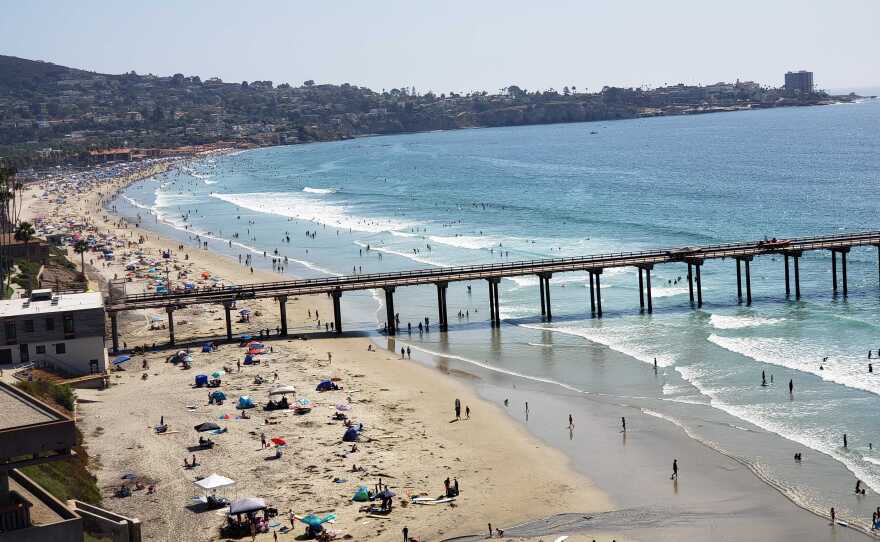 People at the beach by the Ellen Browning Scripps Memorial Pier. Aug. 22, 2020.