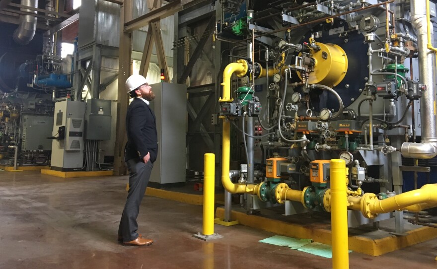 Casey Collins, Duke University energy manager, inspects a boiler at the West Campus Steam Plant. Soon, these boilers will run on swine biogas instead of natural gas.
