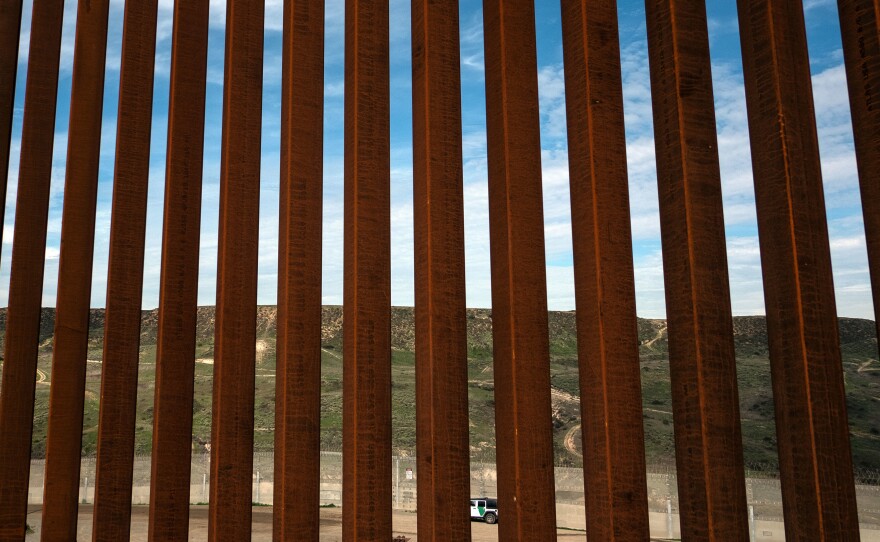 A section of the U.S.-Mexico border fence as seen from Tijuana, Mexico. The California governor plans to split his state's National Guard troops on the border into three new deployments.