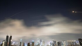 Israeli air defense system fires to intercept missiles during an Iranian attack over Tel Aviv, Israel, early Sunday, March 15, 2026.