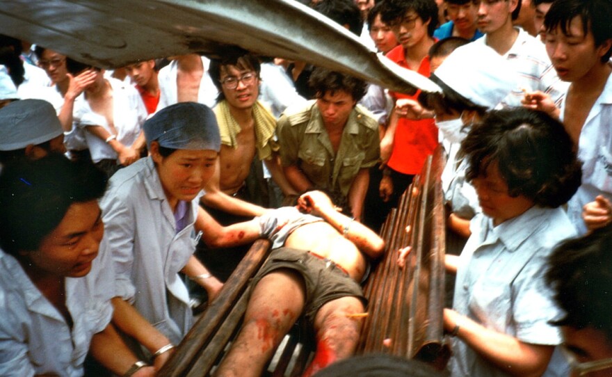 On June 4, a badly injured man is carried into a Chengdu hospital. Witnesses described scenes of police brutality, where people were beaten unconscious simply for being in the wrong place at the wrong time.