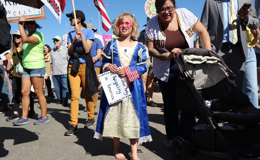 Adele Flowers, 8, holds a sign that reads "I'm the only royalty in America" during a "No Kings" march in San Diego on Saturday, Oct. 18, 2025.