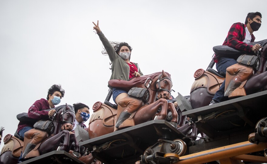 To mask or not to mask: That is the question for vaccinated people as the Delta variant surges. The answer: It depends. Being outdoors reduces the risk of infection. Being shoulder-to-shoulder with screaming people ... look out! Maybe that's why these roller-coaster riders at Knott's Berry Farm in Buena Park, California, masked up.