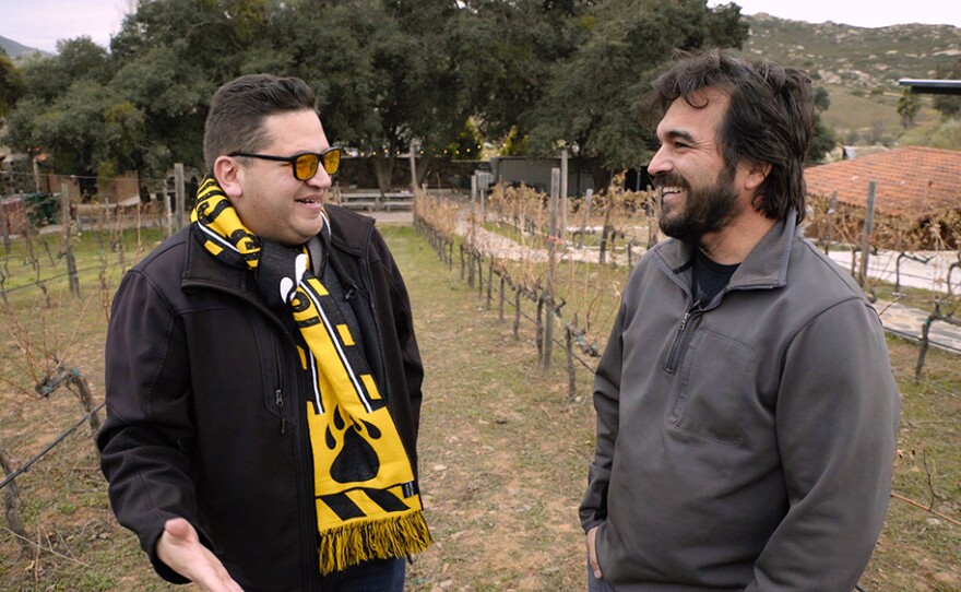 Host Jorge Meraz (left) talks with Noel Téllez (right), the founder of Bichi Wine, in his Tecate vineyard. Baja California, Mexico. 