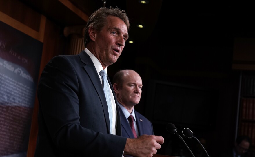 Sen. Jeff Flake, R-Ariz. (left), and Sen. Chris Coons, D-Del., speak to members of the media during a news conference Wednesday on the Special Counsel Independence and Integrity Act.