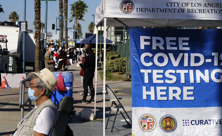 People wait in line to be tested for COVID-19 at a testing site in the North Hollywood section of Los Angeles on Saturday, Dec. 5, 2020. 