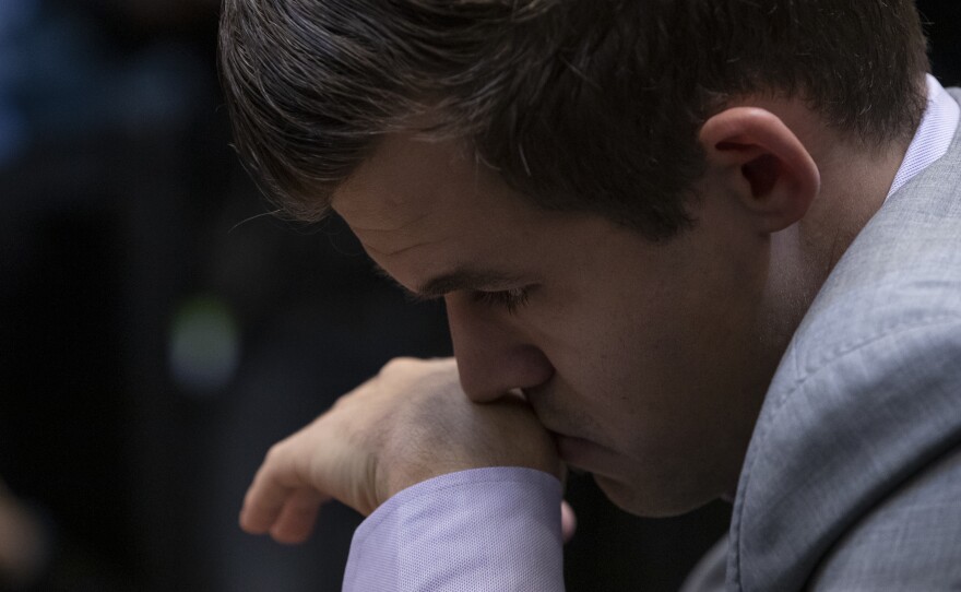 Defending world champion Magnus Carlsen, who is Norwegian, decisively beat his opponent, American Fabiano Caruana, at the World Chess Championship on Wednesday in London.