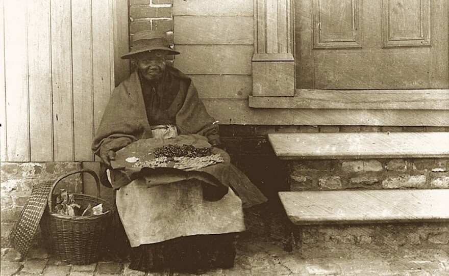 Chloe Jenkins (1843-1899), photographed in Charleston circa 1897, was a so-called "mauma," a free black woman who sold the city's signature groundnut cakes for a penny each.