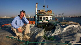 Promotional photo of Michael Palin on a boat from "Around The World In 80 Days - 20 Years On."