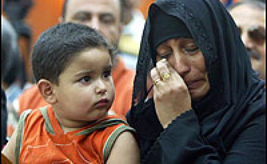 An Iraqi woman attends a ceremony in Baghdad honoring journalists who were killed in acts of violence in Iraq.