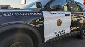Photo of San Diego police cruiser next to a Grocery Outlet on March 14, 2022