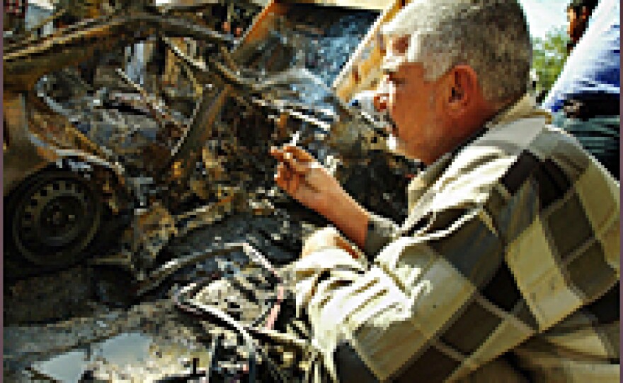 Iraqis gather at the site of a car bomb explosion near a crowded restaurant Nov. 12, 2006 in Baghdad, Iraq.