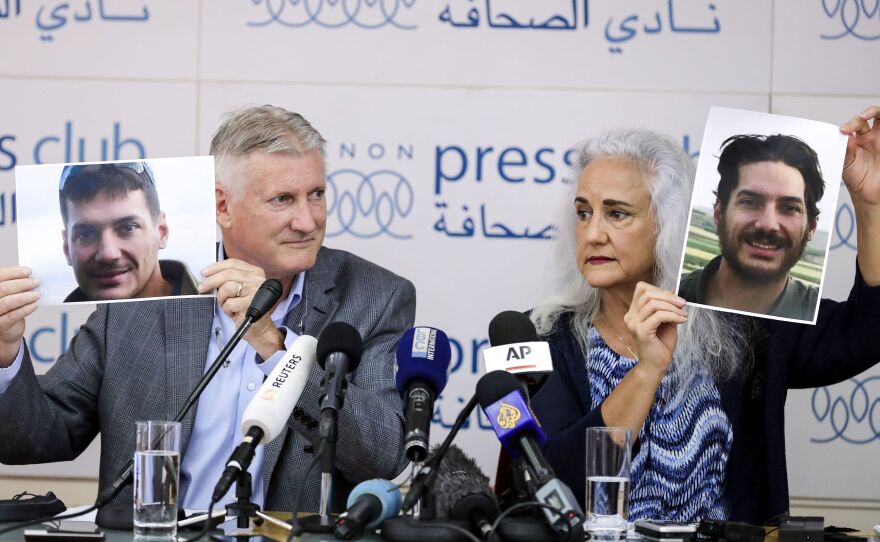 Marc and Debra Tice, parents of American journalist Austin Tice, who was kidnapped in Syria in 2012, hold portraits of him during a news conference in Beirut in 2017.